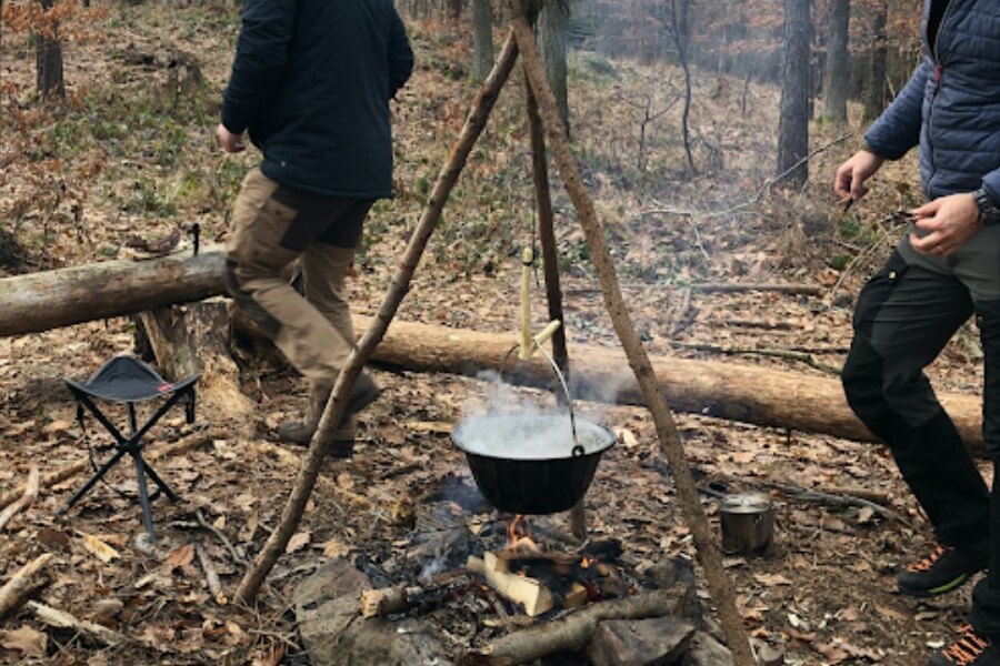 Ceaun de gătit agățat pe un trepied de crengi