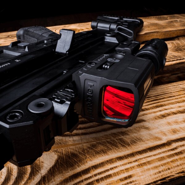 Detaliu al unui colimator de armă cu filtru optic roșu pe o pușcă modernă, montat pe o șină Picatinny. Foto: Rigad